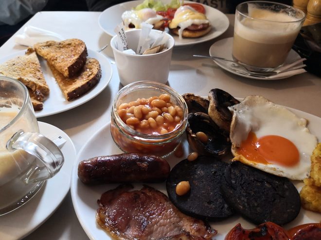 A laid table with breakfast, latte and toast