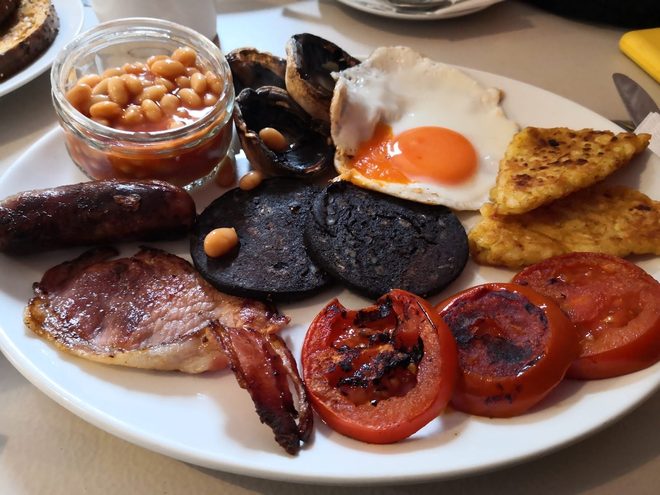 Close-up of bacon, black pudding, sausage and fried egg
