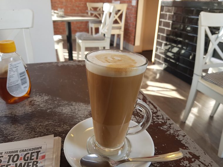 Latte in a tall glass with latte art