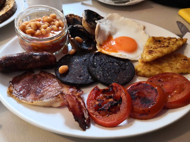 Breakfast plate with black pudding, bacon, sausage and beans